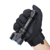 Hand in black tactical glove holding black Olight flashlight with blue bezel.