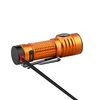 Orange Baton 3 Pro Max flashlight charging. Magnetic base connected to a black USB cable.