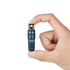 Olight Blue Imini 2 Flashlight Held Between Fingers, USB Magnetic Charger for Everyday Carry
