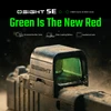 Olight Osight SE Red Dot Sight Close-up with Green Lens and Sand for Tactical Shooting