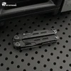 HX Outdoors compact black multi-tool folded on a black perforated metal surface.