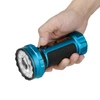 Hand holding blue Marauder Mini 2 flashlight, isolated on white background.