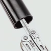NexTool multitool ruler measuring the inner diameter of a black metal pipe, highlighting precision measurement features.