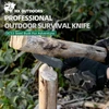 Gloved hand using HX OUTDOORS professional survival knife to split wood outdoors.