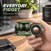 Hand holding green GoBiggeR everyday fidget toy with smooth rotation and tactile feedback features for stress relief