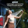 Happy woman enjoying portable shower outdoors near car, lightweight and powerful for wild camping.