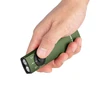 Person's hand gripping a green compact flashlight with a black control panel and two front lights