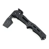 Black multi-functional folding camping tactical axe with textured handle on white background