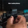 Hand loading a side-loading battery into a black tactical red dot sight mounted on a firearm.