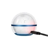 A white globe night light with sky patterns, a blue base and band, and a charging cable plugged in.