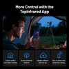 Man in tent using phone app to control thermal camera on tripod, remotely capturing images.