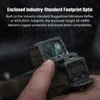 Man's finger presses rugged Osight XE AMRS optic, covered in raindrops, on a pistol, highlighting its durability and compatibility.