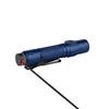 Blue tactical flashlight with pocket clip charging via magnetic cable on white background