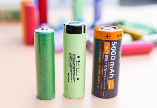 Three rechargeable batteries of different sizes and capacities, including a 5000 mAh Li-ion battery, displayed on a tabletop.