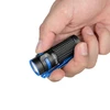 Olight Black and Blue Baton 4 Premium Edition in hand, showing textured grip and pocket clip for everyday carry.