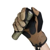 Gloved hand holding an Olight olive green tactical flashlight against a white background