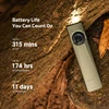Olight OD Green Arkfeld Ultra flashlight shining on tree bark, highlighting long battery life for outdoor adventures.