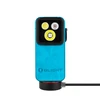 Olight light blue rectangular flashlight with three LED lenses charging on a magnetic base against a white background