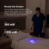 Olight ArkPro Ultra UV flashlight revealing hidden elements on a bed for professional inspection.