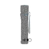 Compact textured black tactical flashlight with pocket clip and lanyard ring isolated on white background