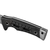 Ergonomic textured black G10 handle of a full tang tactical survival knife with silver steel bolster and lanyard hole