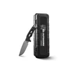 HX Outdoors survival knife with textured black handle leaning against protective hard carry case isolated on white background