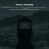 Red dot sight with night vision mode reticle aiming at distant mountains under low light conditions