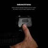Finger pressing the dedicated NV button on a red dot sight to switch between daylight and night vision modes.
