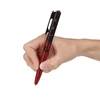 Olight Red and Black Open 3 EDC Penlight Held in Hand for Writing and Everyday Carry