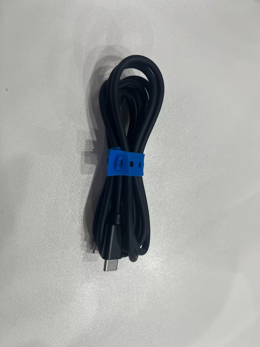 Olight Black Ostation X AA USB-C Charging Cable Coiled with Blue Silicone Strap for Power Supply and Device Connection