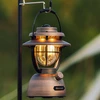 Olight Olantern Classic 2 Pro hanging from a hook, emitting warm light for outdoor illumination.