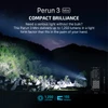 Olight Black Perun 3 Mini Flashlight illuminating a dark mountain at night with 1250 lumens for outdoor camping SEO