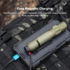 Olight tactical flashlight charging with a magnetic USB cable on a portable power bank outdoors.